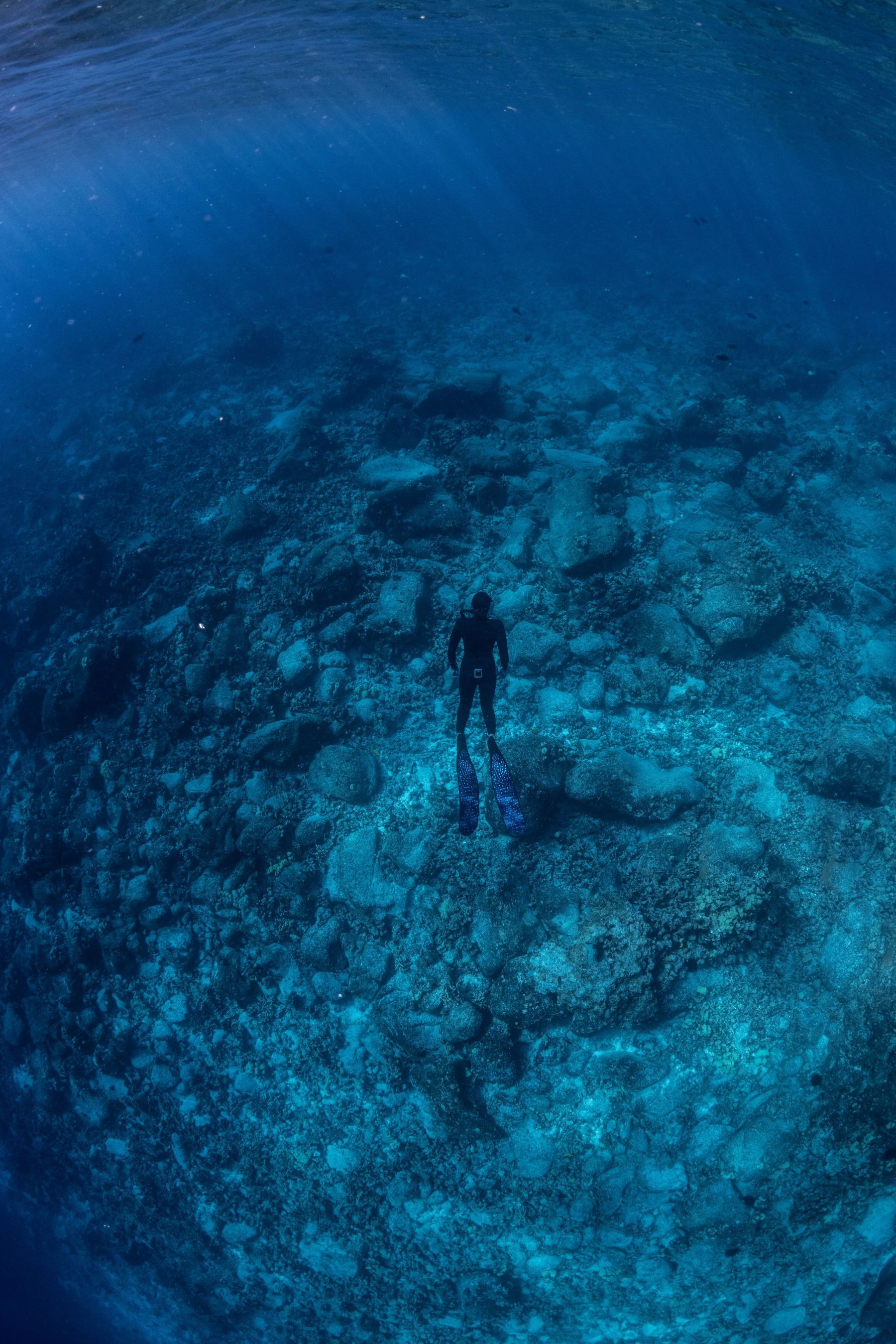 A woman is standing in the middle of a large body of water.