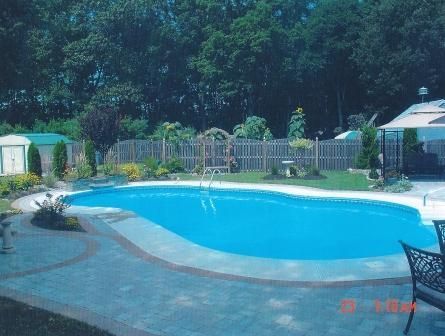A large swimming pool in the backyard of a house