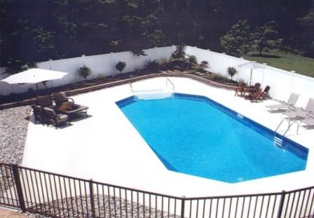 A large swimming pool surrounded by chairs and umbrellas
