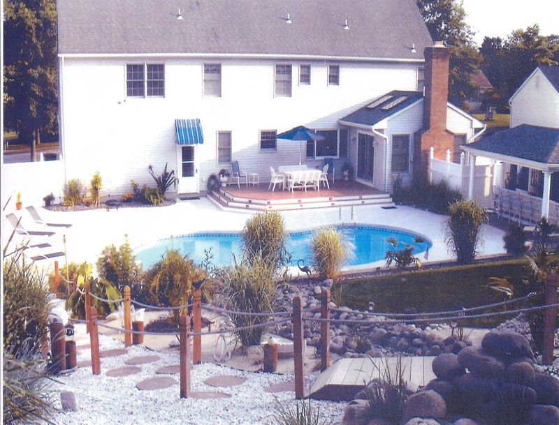 A large white house with a swimming pool in front of it