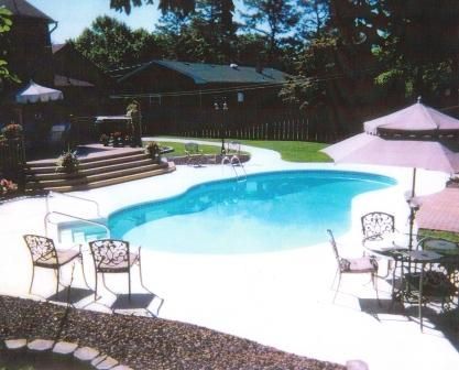 A large swimming pool surrounded by chairs and umbrellas