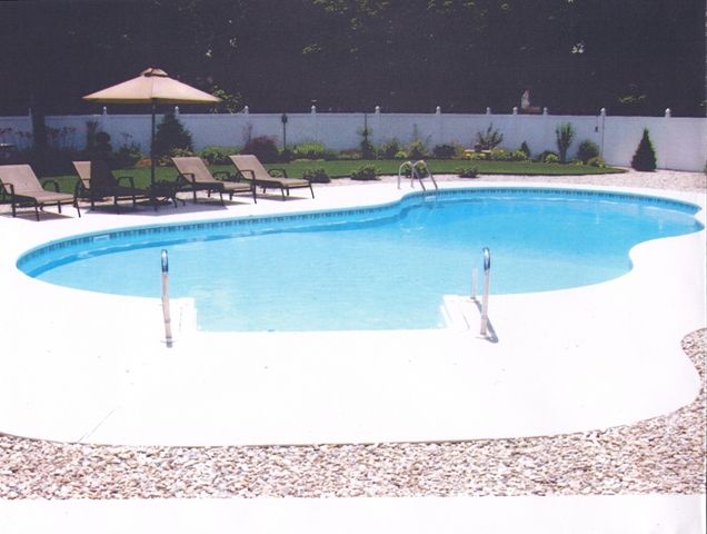 A large swimming pool surrounded by chairs and umbrellas