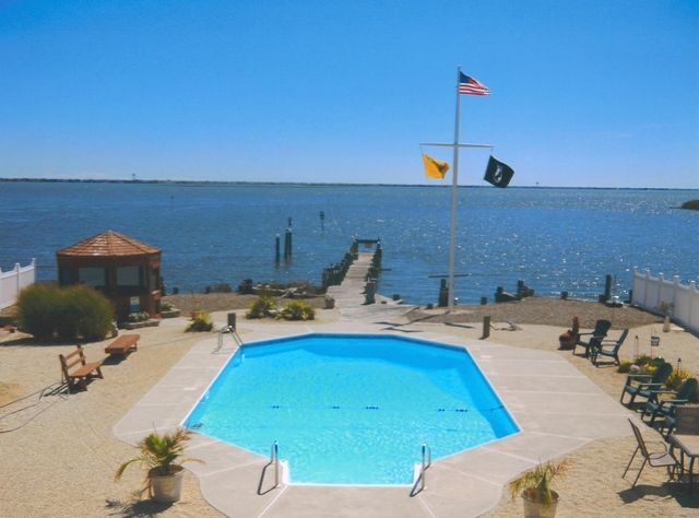 An aerial view of a swimming pool overlooking a body of water