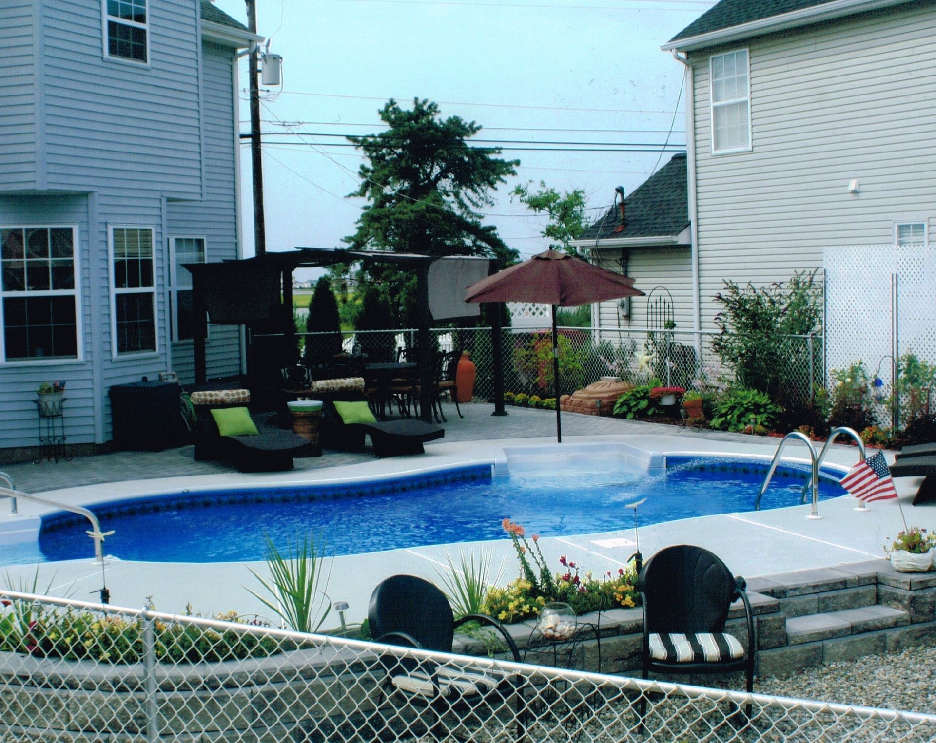 A large swimming pool in the backyard of a house