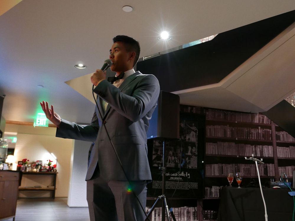 A man in a suit is singing into a microphone