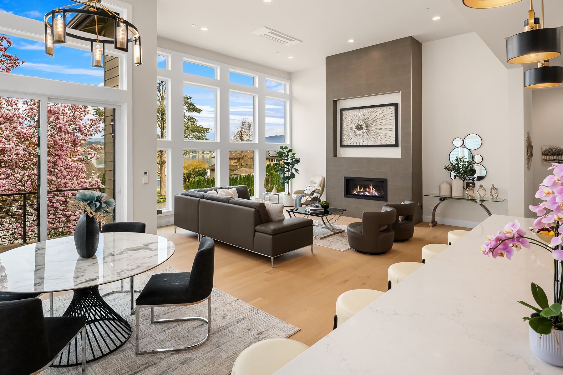 A living room with a fireplace , couch , coffee table and chairs.
