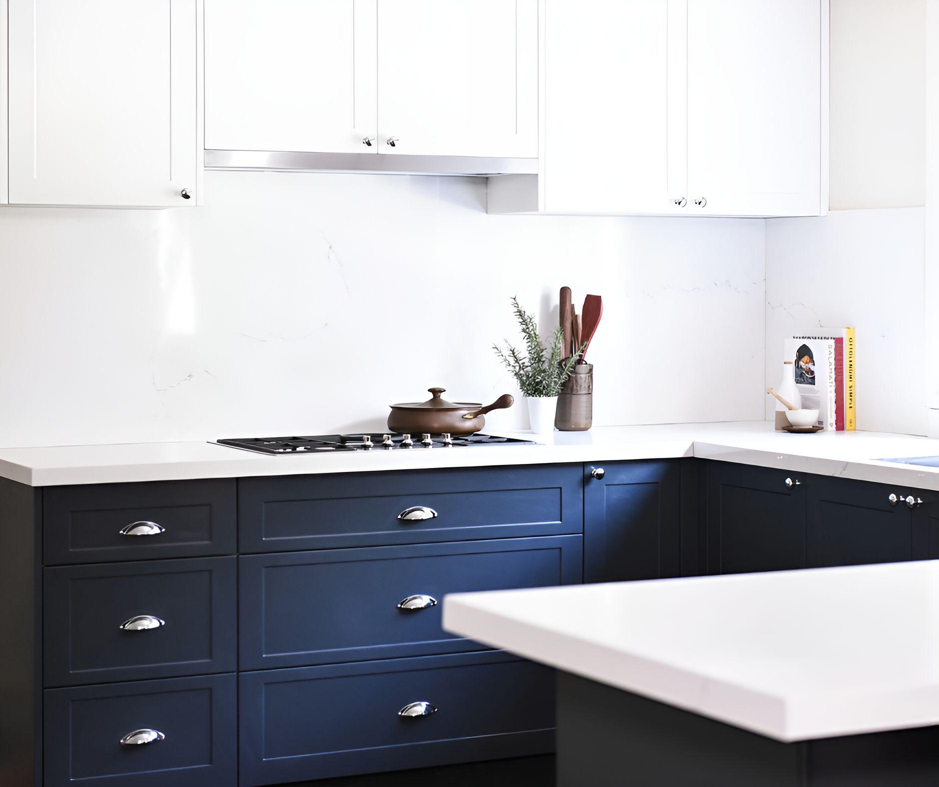 A Kitchen With Blue Cabinets And White Counter Tops — Wards Kitchens in Berkeley Vale, NSW