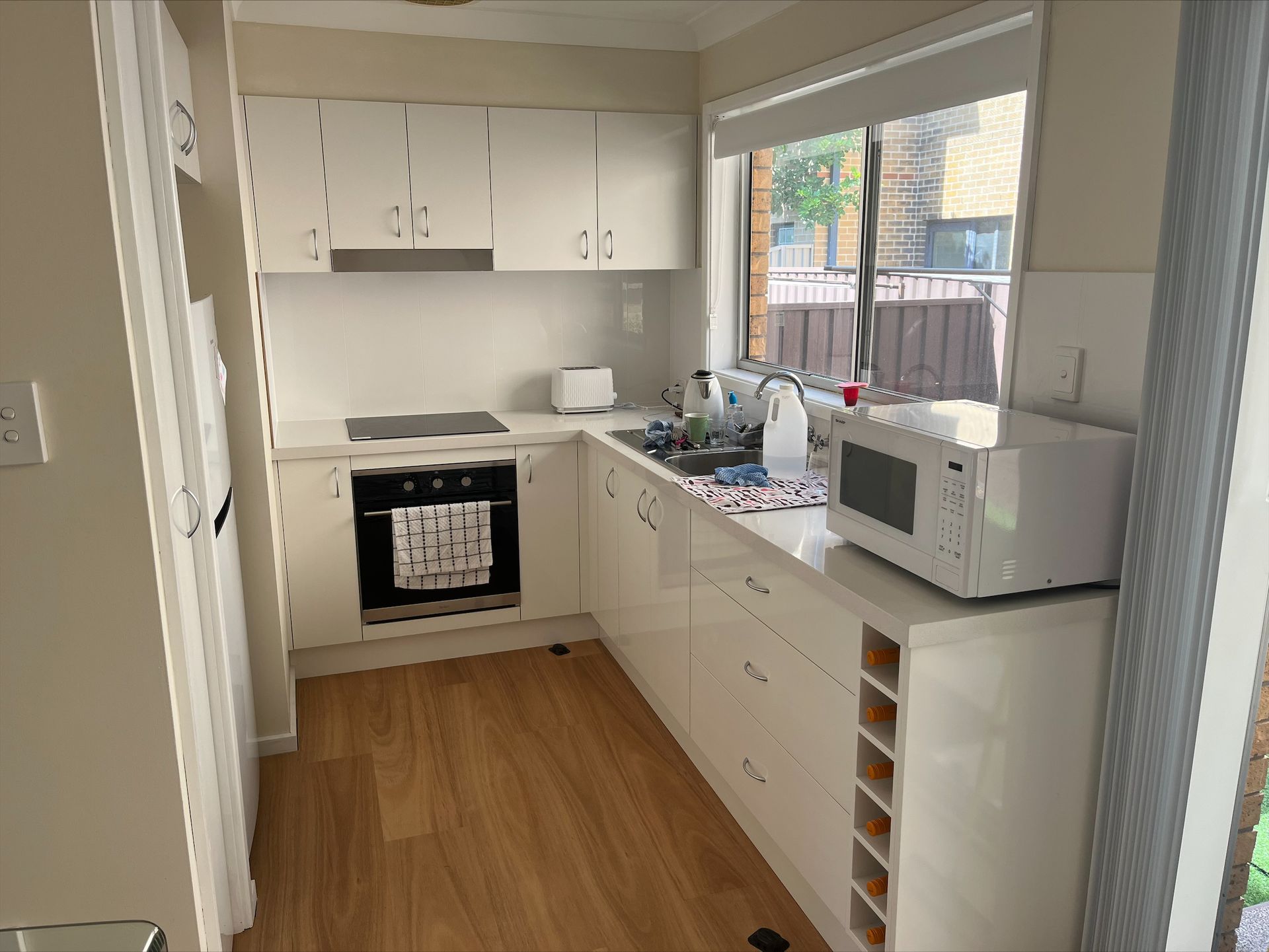 A Kitchen With Wooden Cabinets And A White Refrigerator — Wards Kitchens in Berkeley Vale, NSW