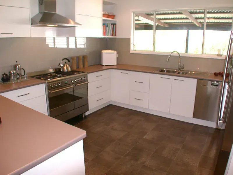 Before photo of Modern white kitchen with stainless steel appliances, brown countertops and flooring - Wards Kitchens In Central Coast, NSW