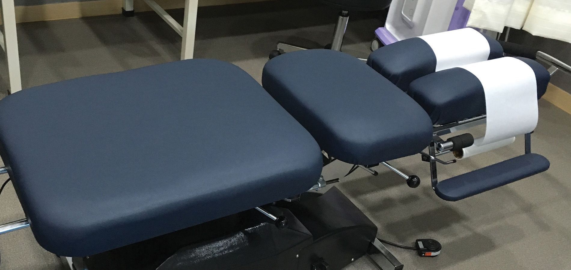 a blue massage table is sitting on the floor in a room