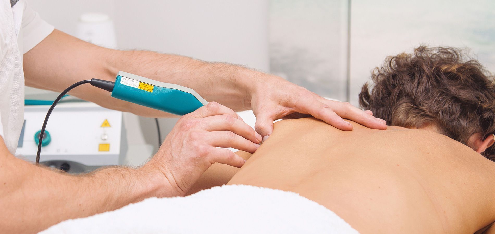 a man is getting a massage with a machine on his back .