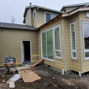 A house with a lot of windows is being built.