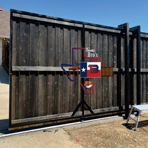 A wooden fence with a sign that says texas bros