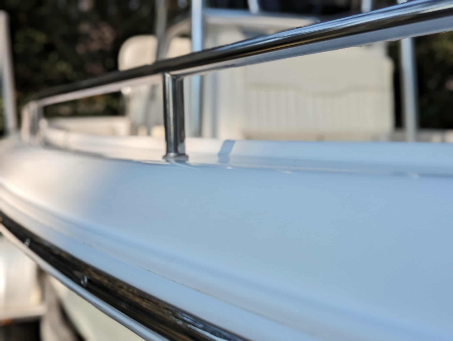 White boat deck with stainless steel railing, outdoors.