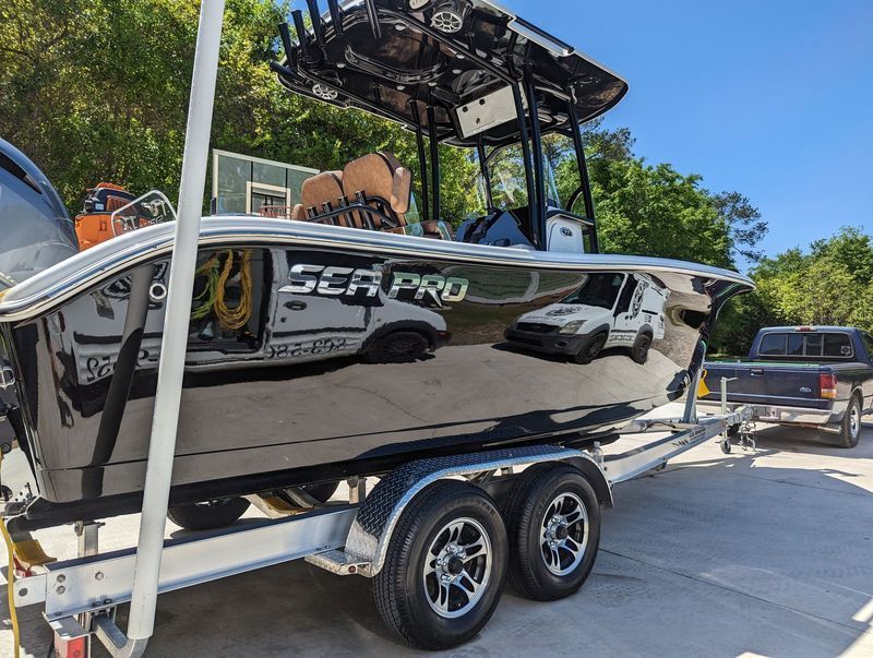 Black Sea Pro boat on a trailer, with a truck in the background, parked outdoors.