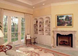 A living room with a fireplace and a painting on the wall.