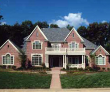 A large brick house with a gray roof and white trim