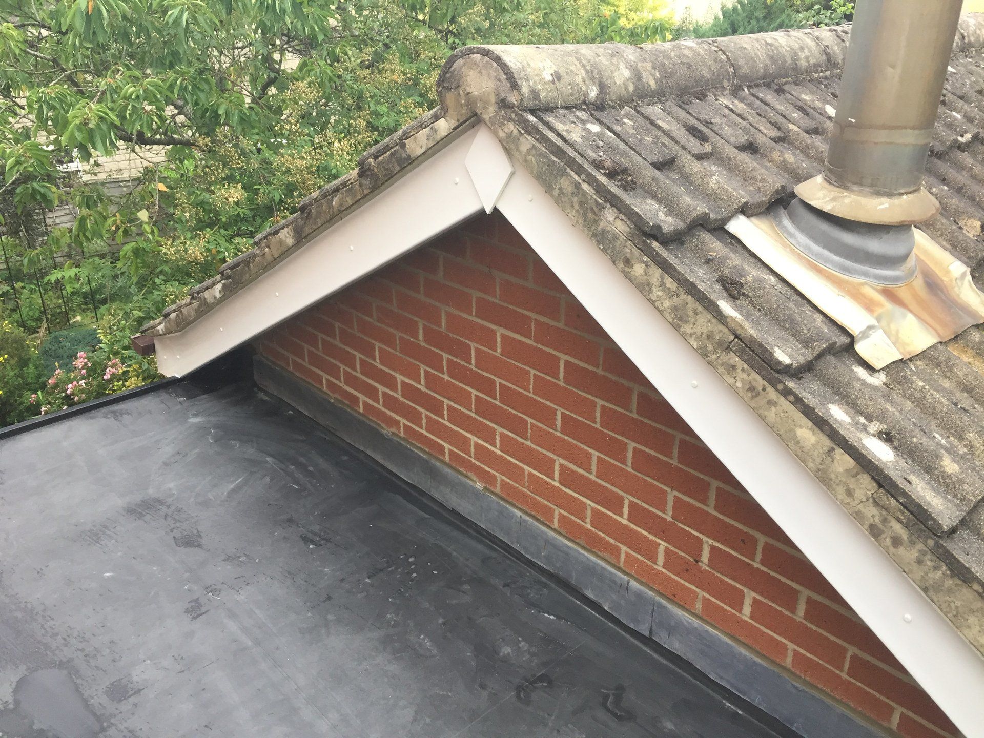 new flat roofing against pitched gable