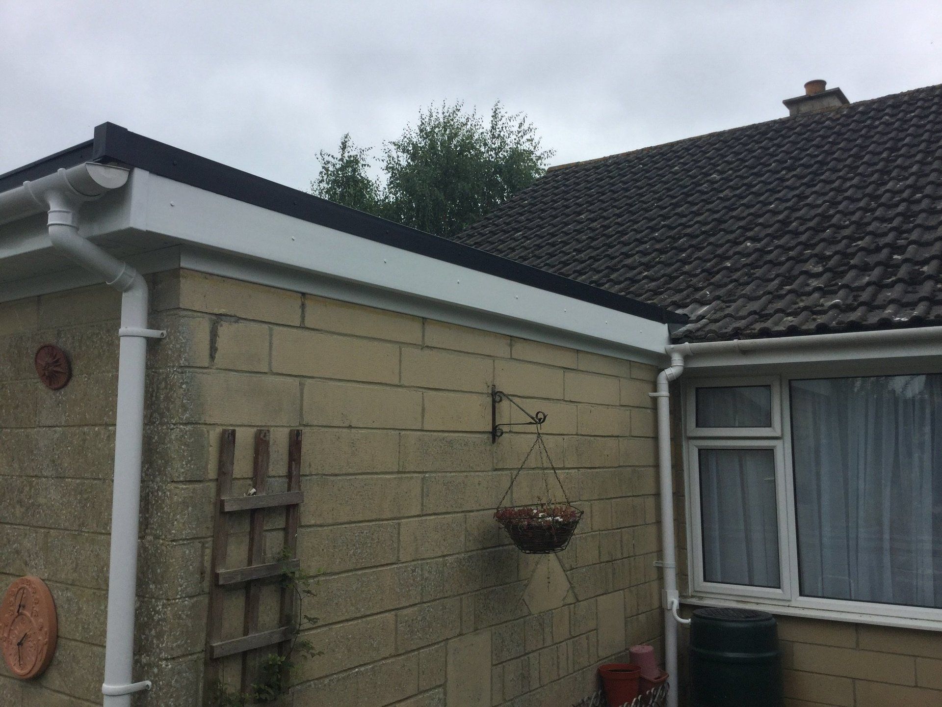side view from ground of extension with new down pipe and guttering