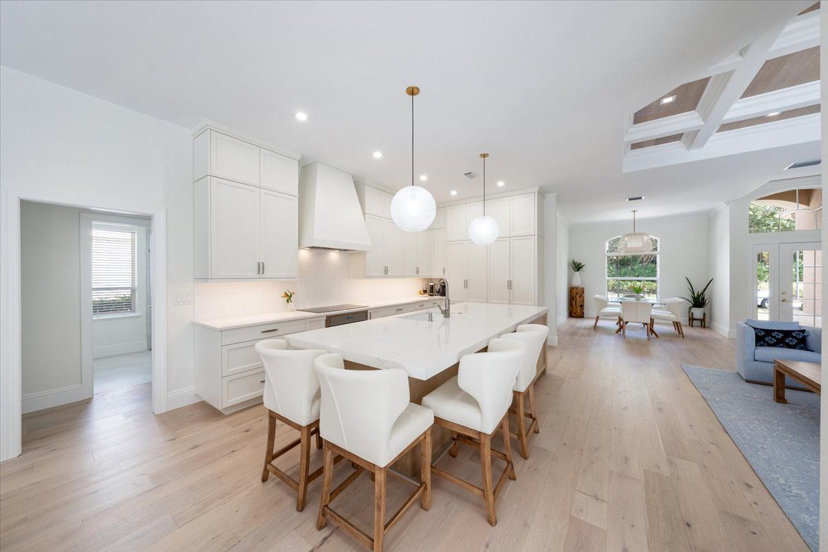 A kitchen with a dining table and chairs in it.