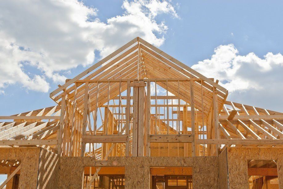 A house is being built with a blue sky in the background.