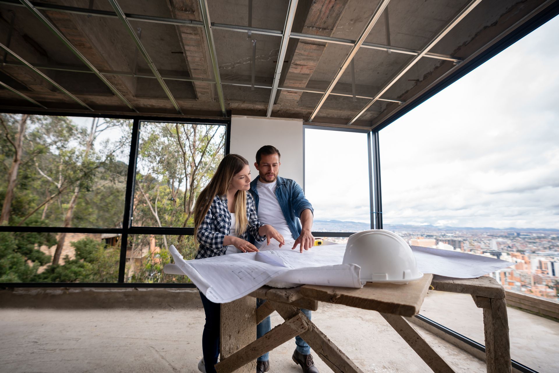Person and person looking at a blueprint.