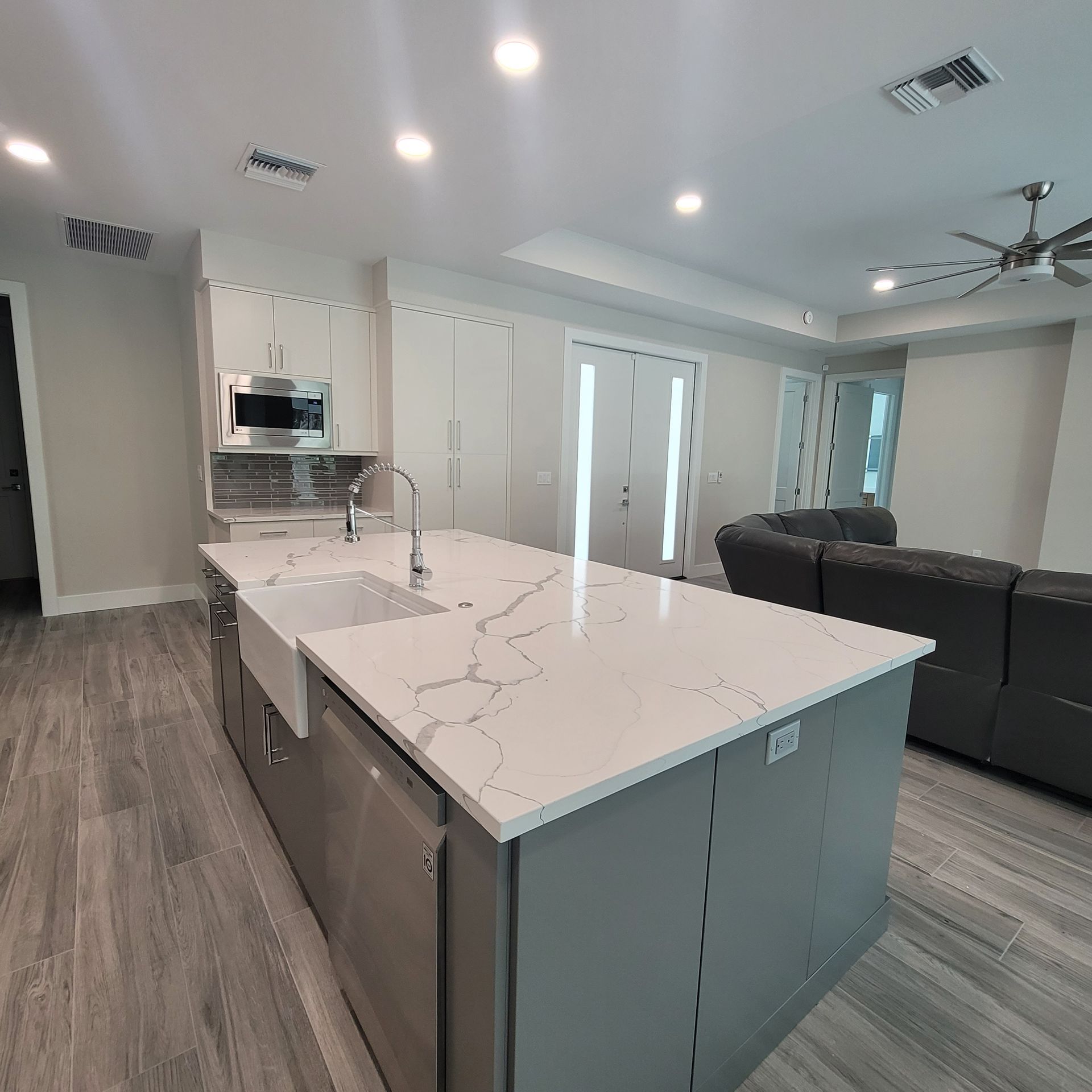 A kitchen with a large island and a sink.