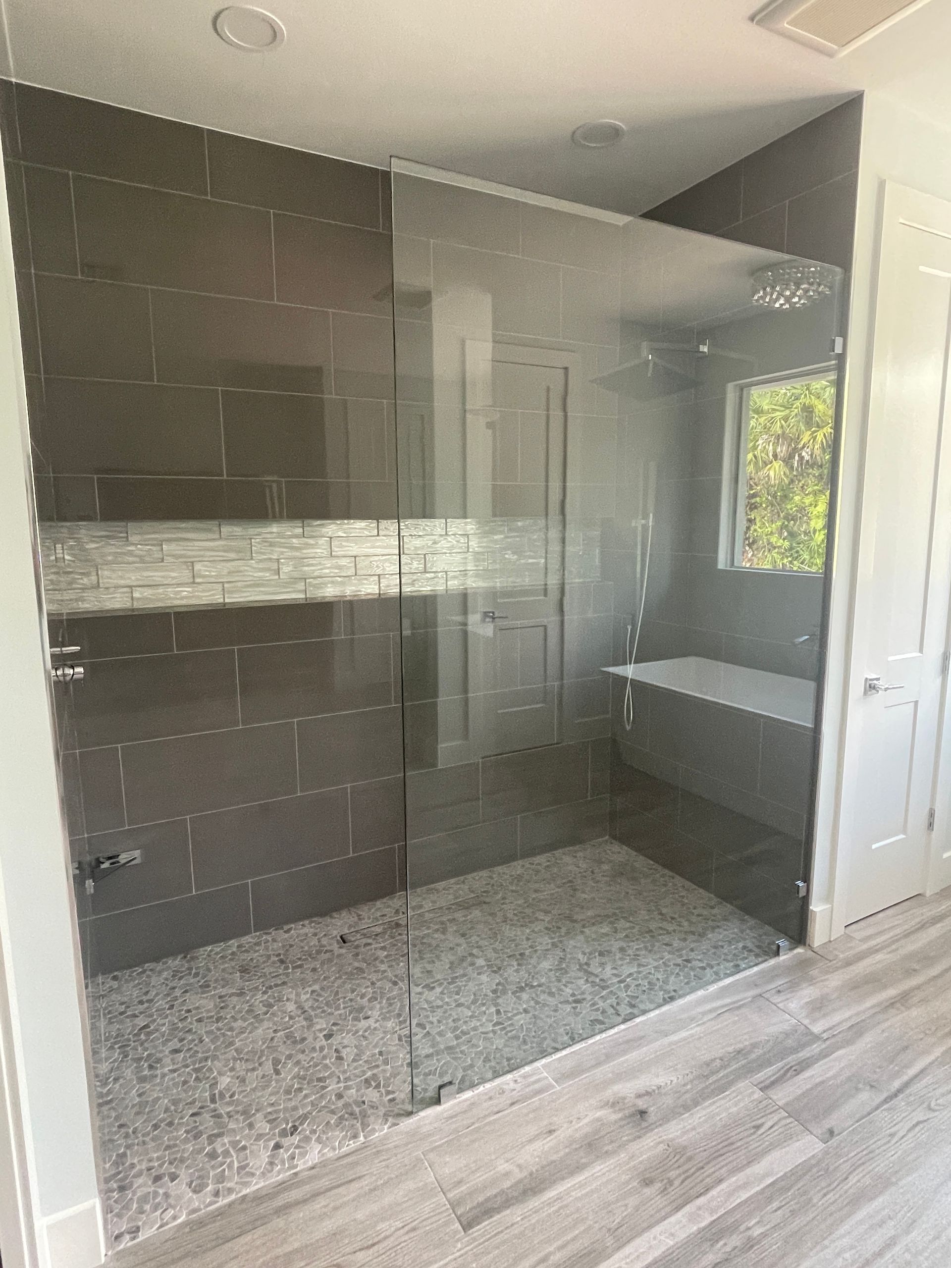A bathroom with a walk in shower and a bathtub.