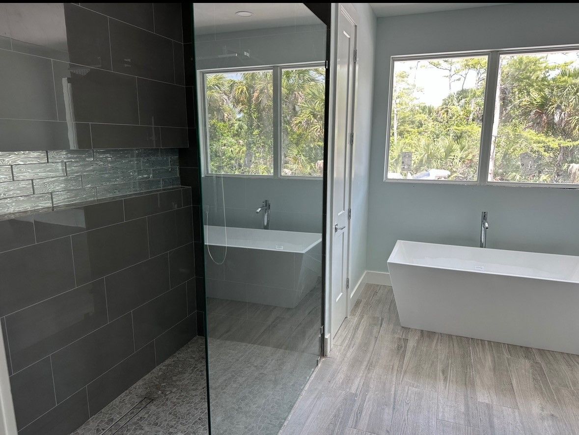 A bathroom with a bathtub and a walk in shower.