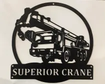A black metal sign featuring a mobile crane silhouette inside a circle above a nameplate that reads, SUPERIOR CRANE.