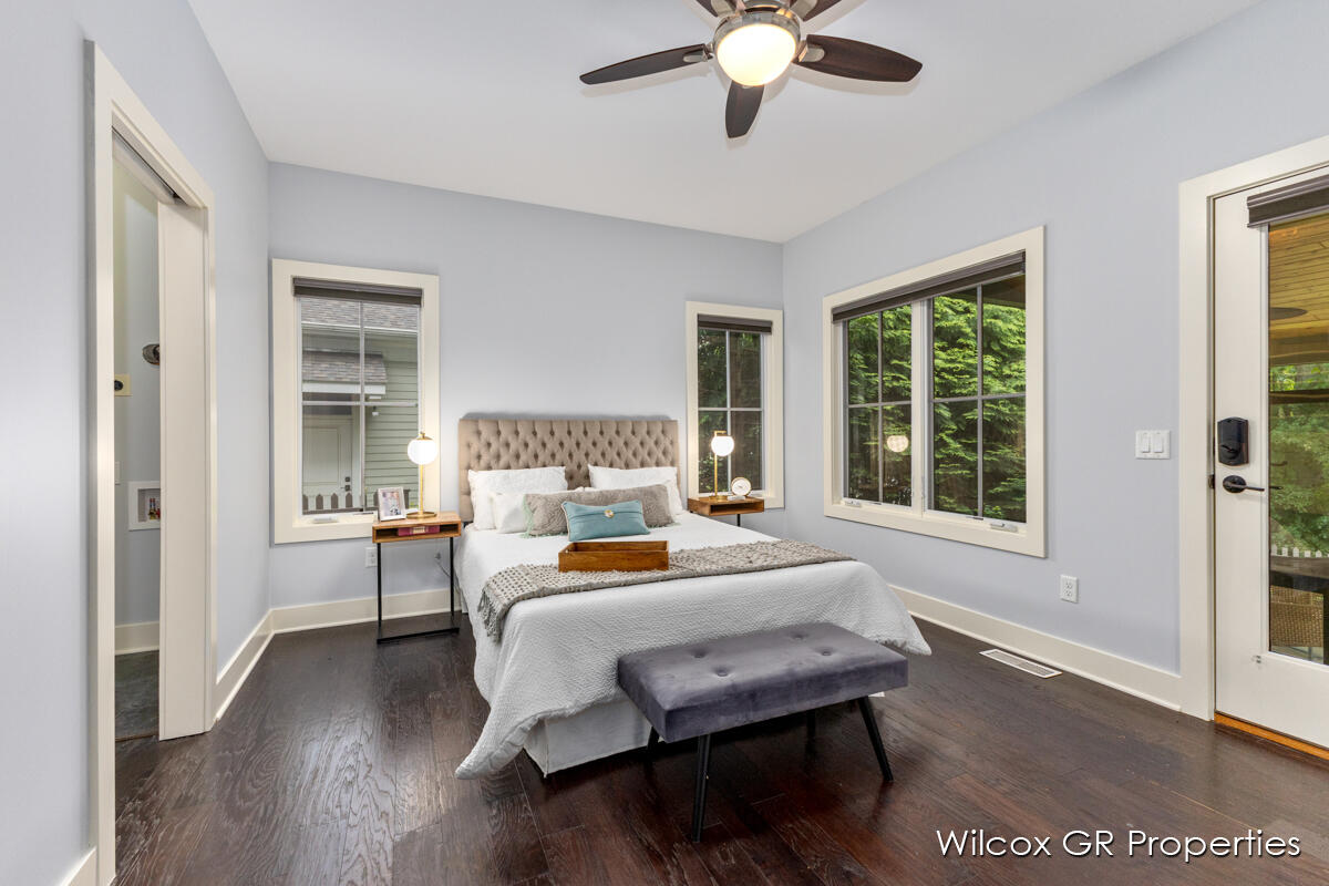 A bedroom with a large bed and a ceiling fan.