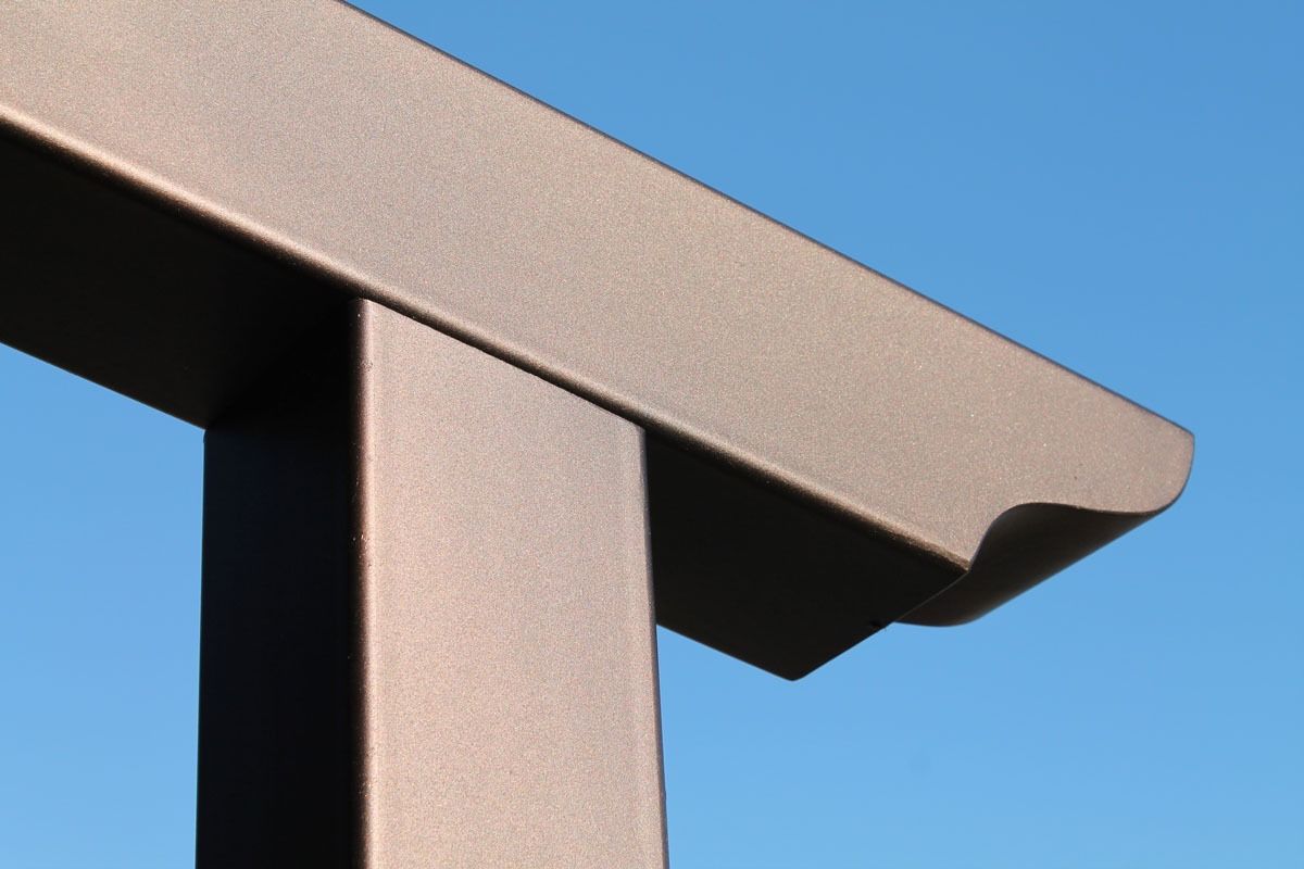 Angolo di pergola marrone contro un cielo azzurro terso.