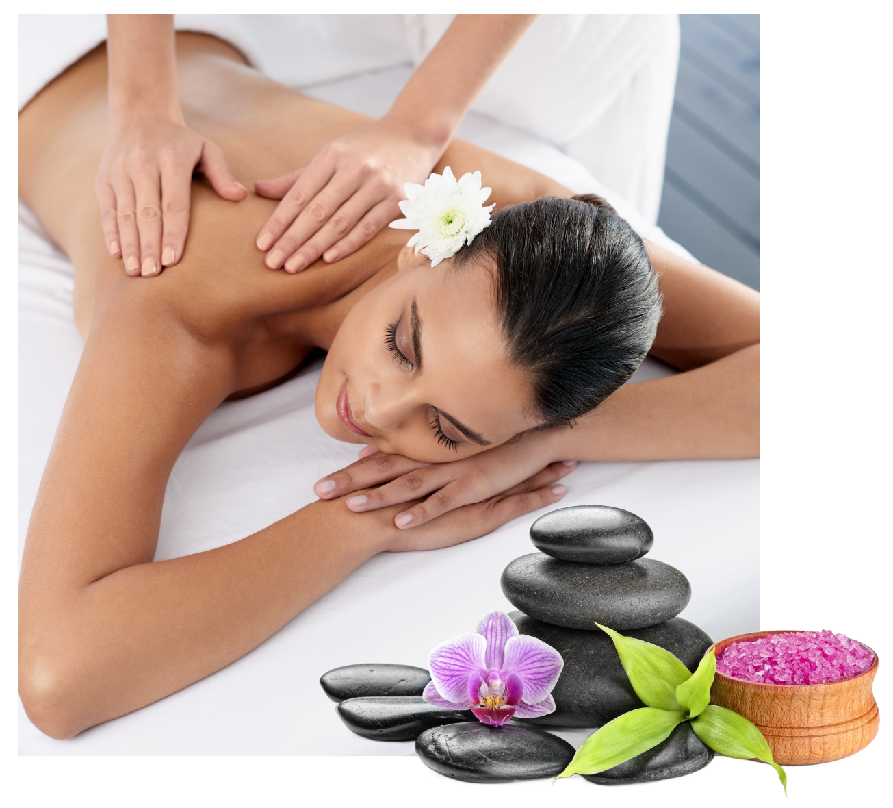 A woman is getting a massage with a flower in her hair