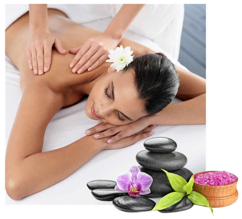 A woman is getting a massage with a flower in her hair