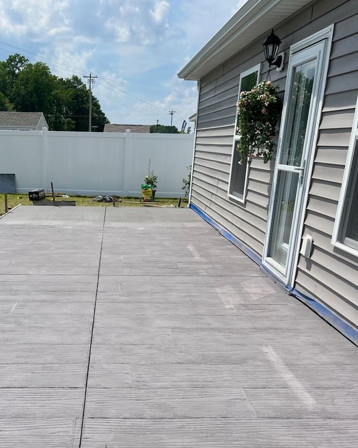 A house with a wooden deck in front of it.
