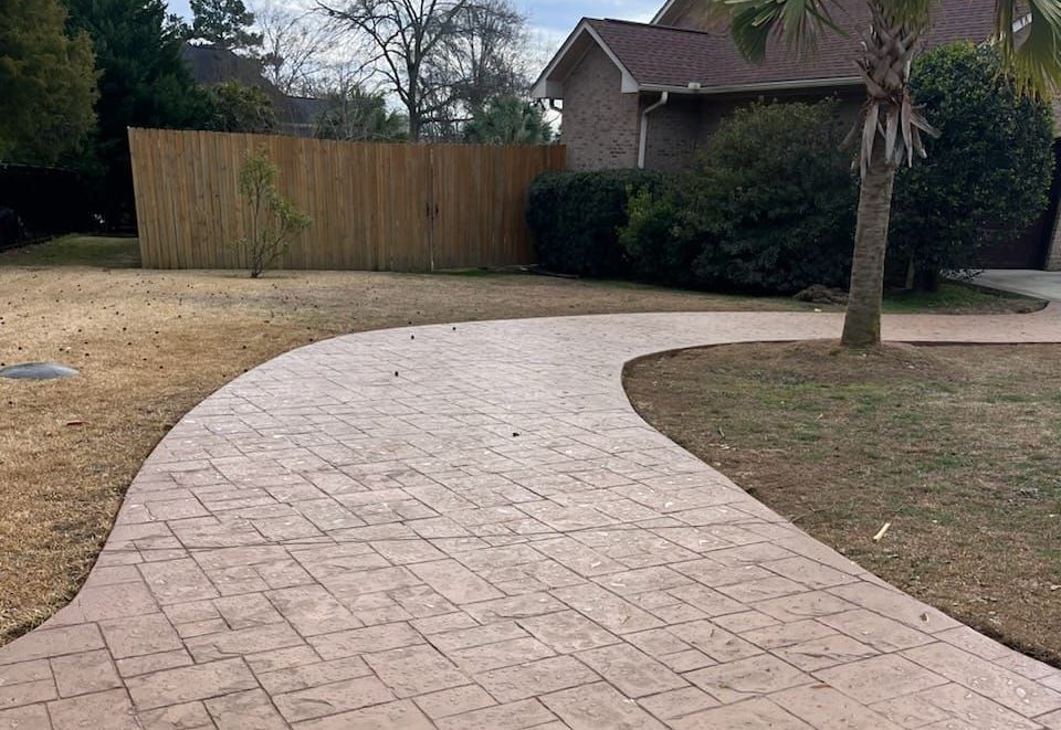 A large house with a brick driveway in front of it