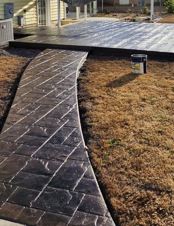 A concrete patio with a wood grain pattern on it.