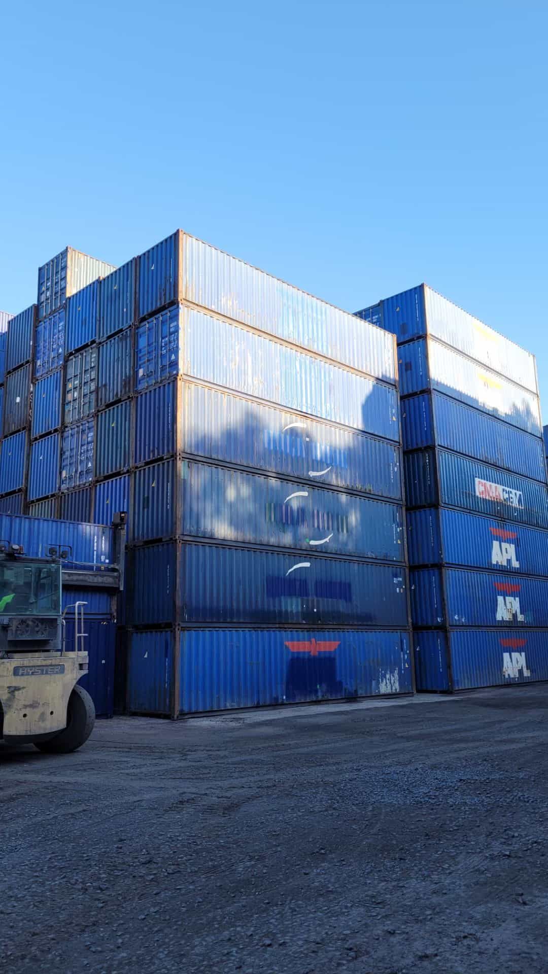 A Forklift Is Driving In Front Of A Large Stack Of Shipping Containers — TSR Total Shipping Containers In Port Macquarie, NSW
