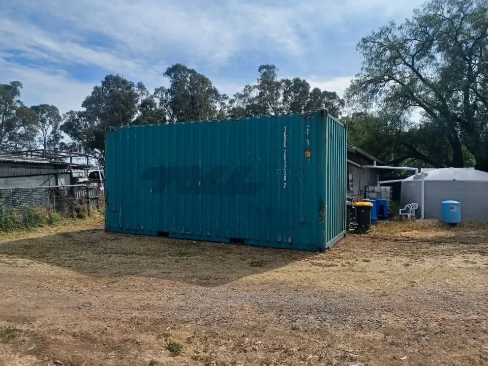 A Blue Shipping Container Is Sitting In The Middle Of A Dirt Field — TSR Total Shipping Containers In Port Macquarie, NSW