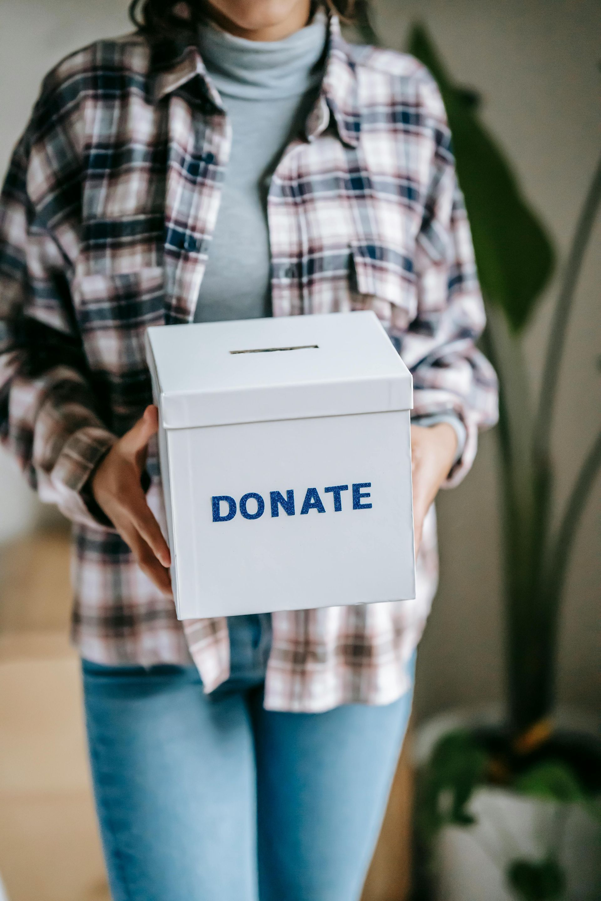 Woman holding a white donation box with