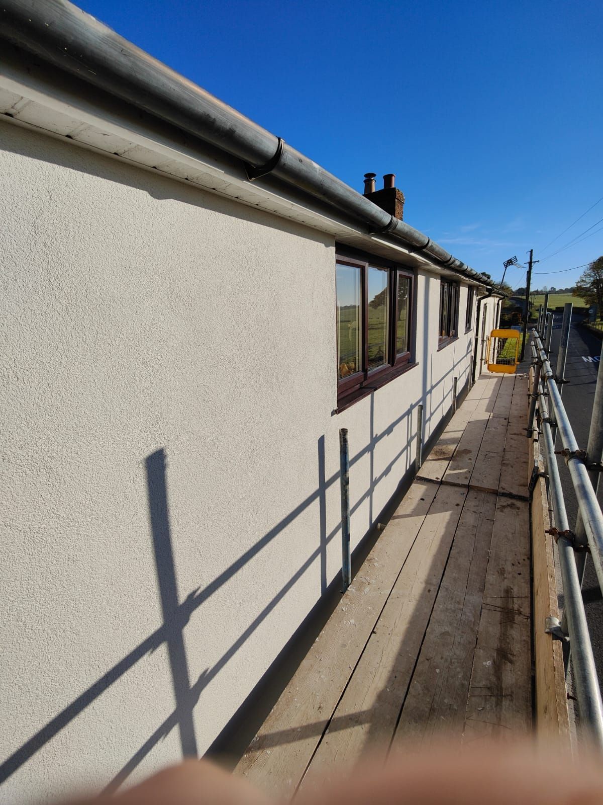 Scaffolding next to a building with external render.