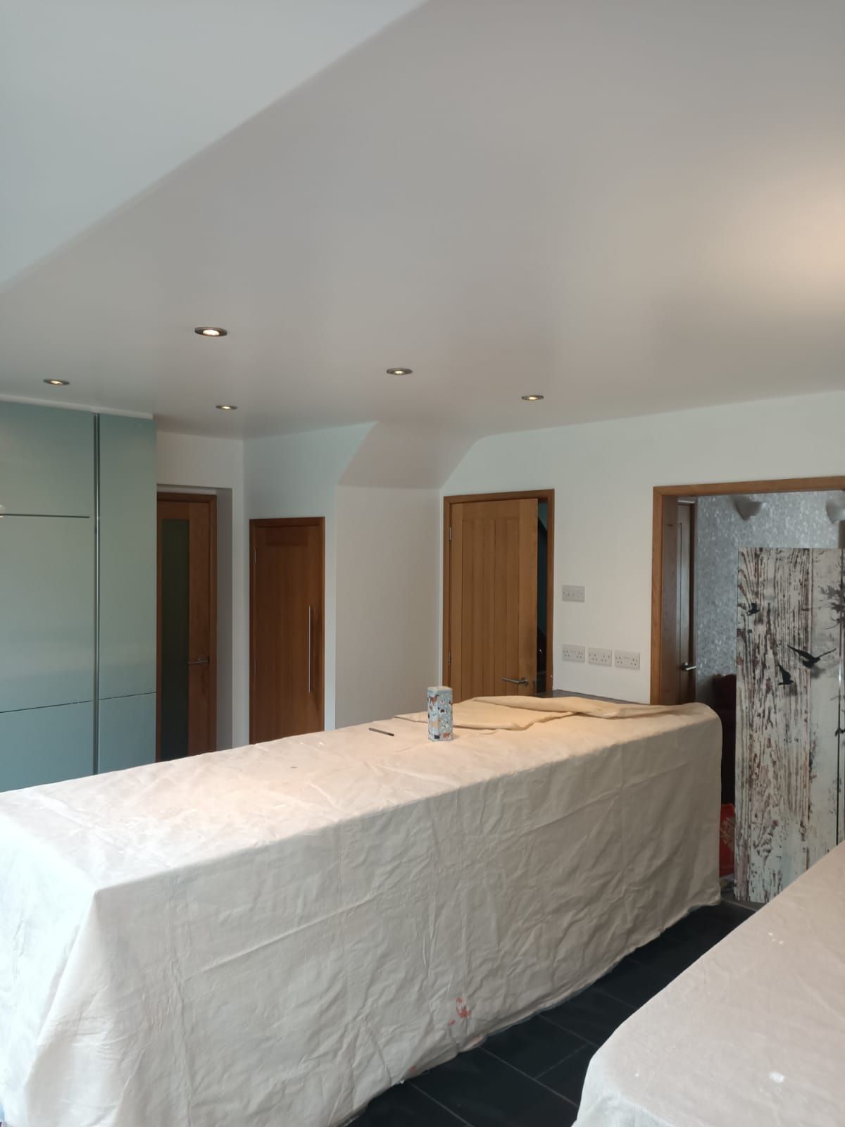 A long table with a white cloth on it in a room
