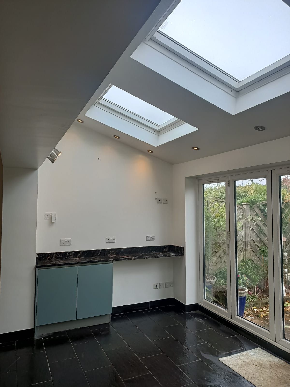 An empty room with a skylight and a lot of windows.