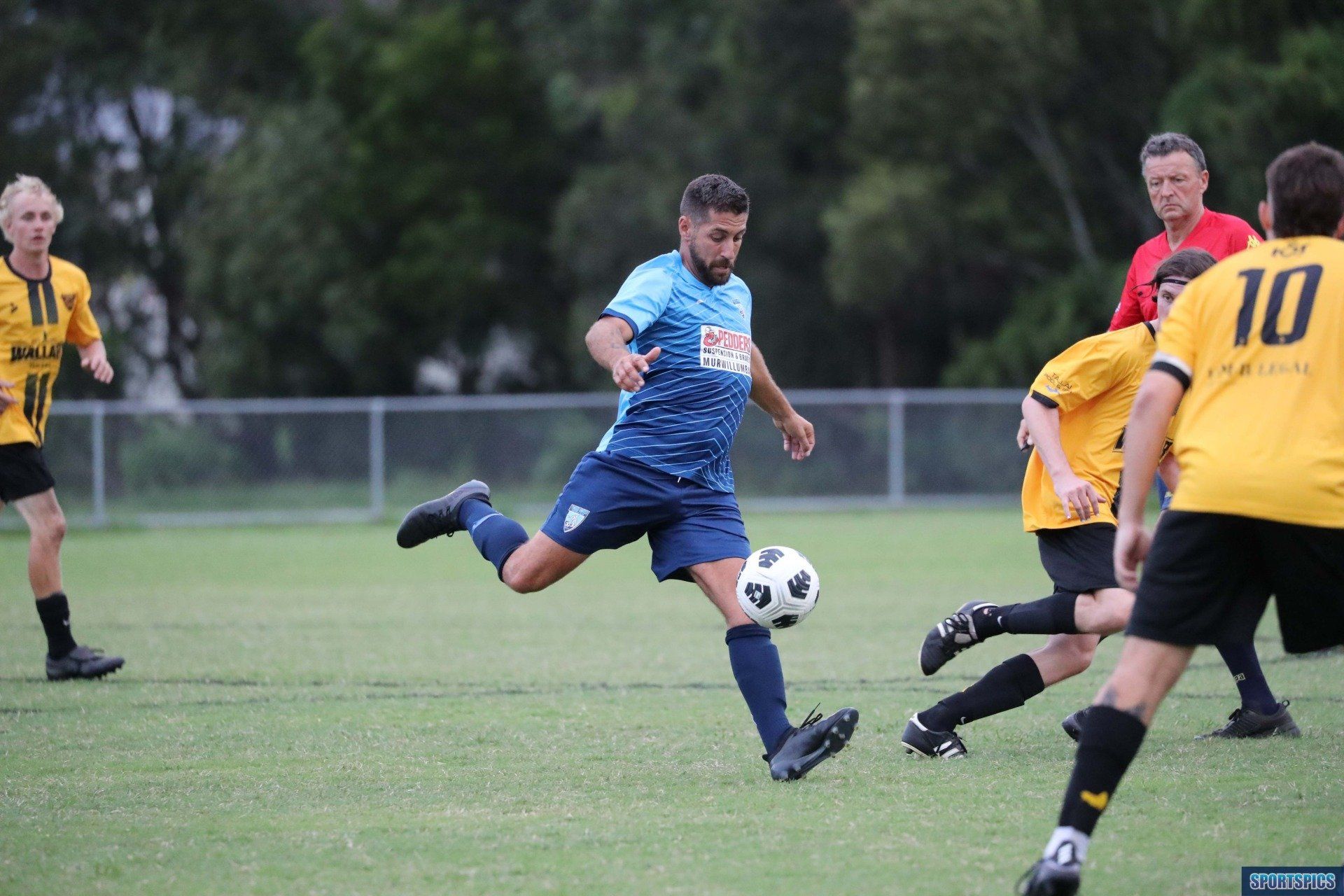 tweed united footballer striking the ball