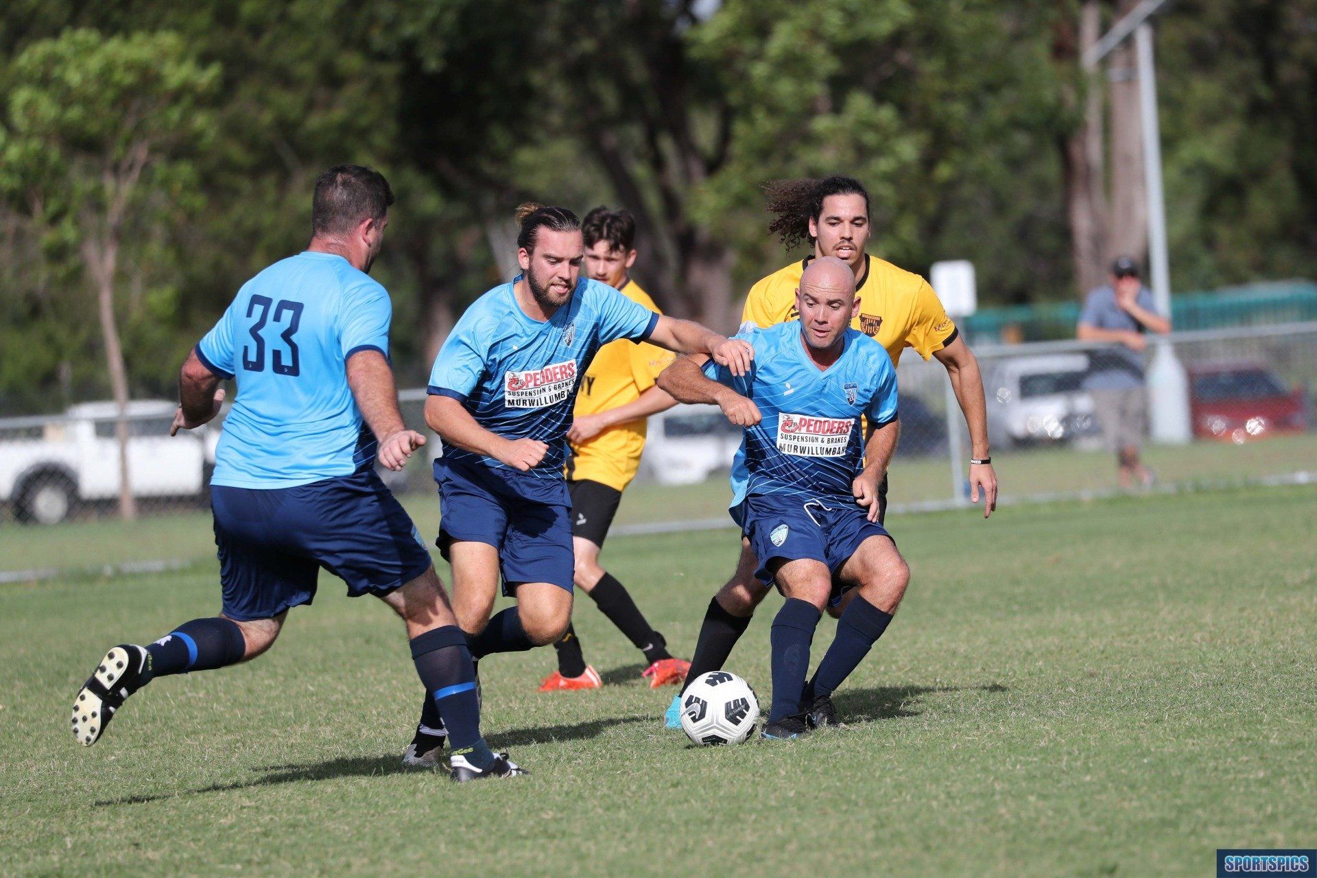 tweed united footballer dribbling the ball