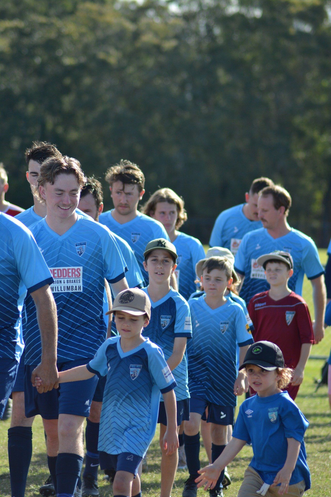 tweed united men walking the boys team out