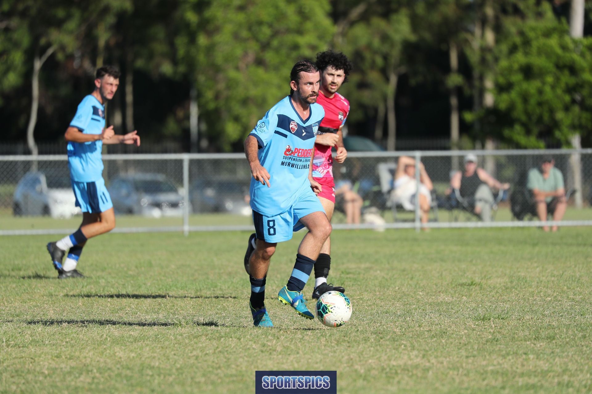 tweed united footballer dribbling the ball