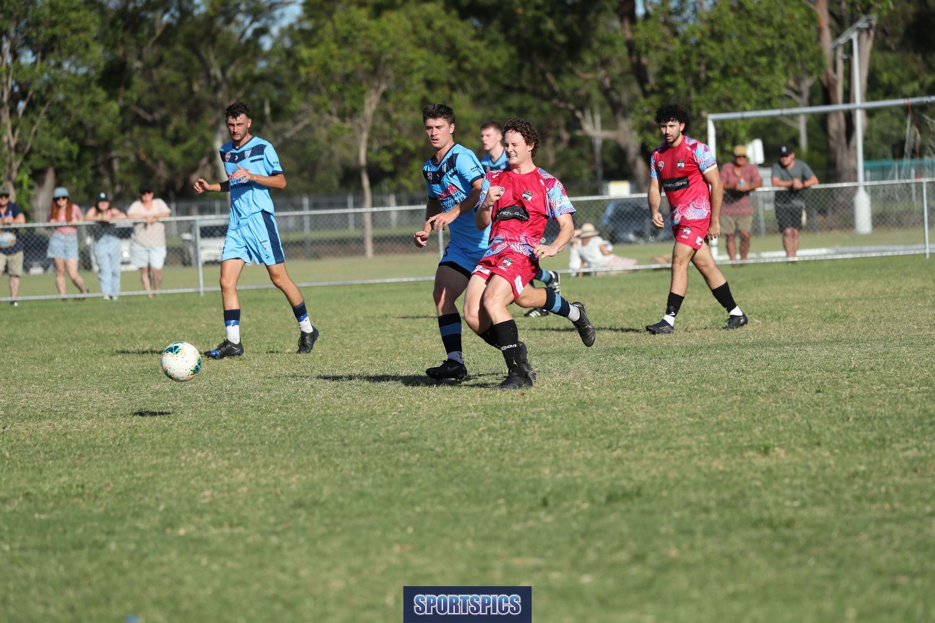 tweed united footballer defending the ball