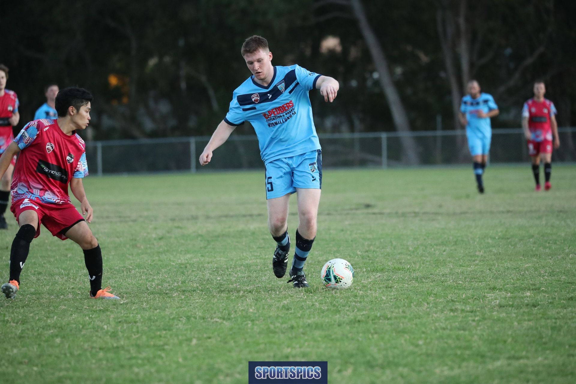 tweed united footballer dribbling the ball