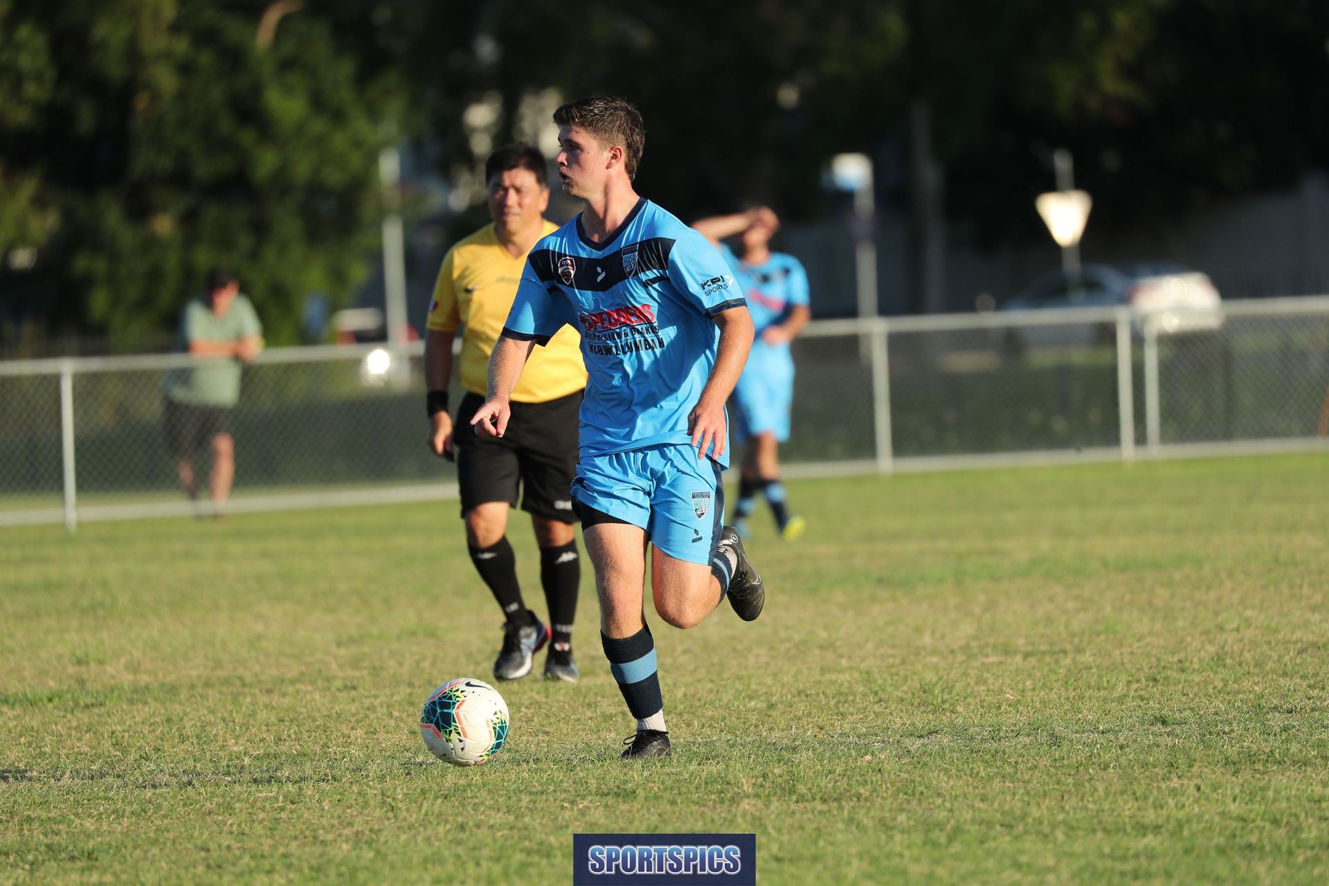 tweed united footballer dribbling the ball
